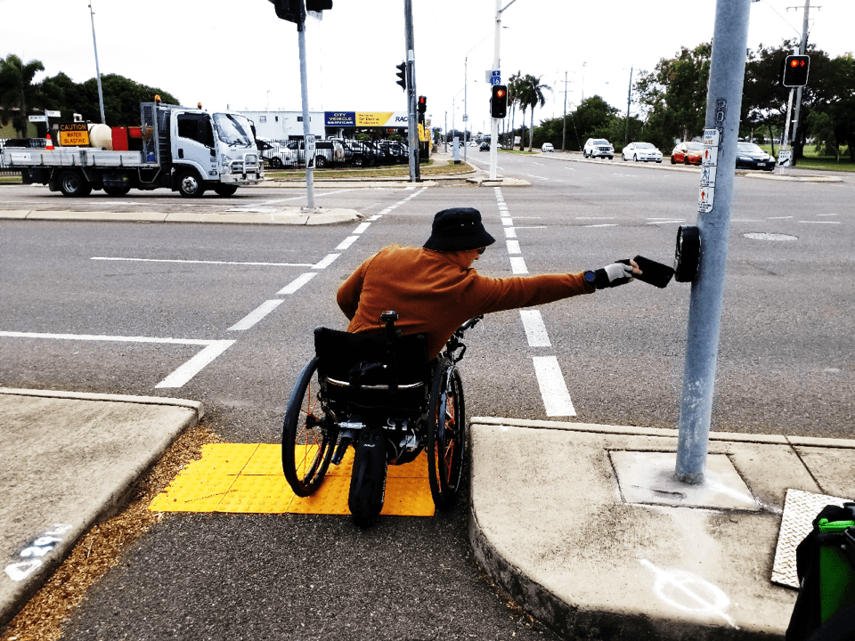 WC Pilot Jason stretches to reach traffic light button